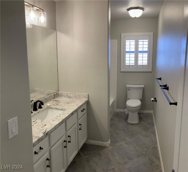 bathroom with vanity, tile patterned floors, and toilet