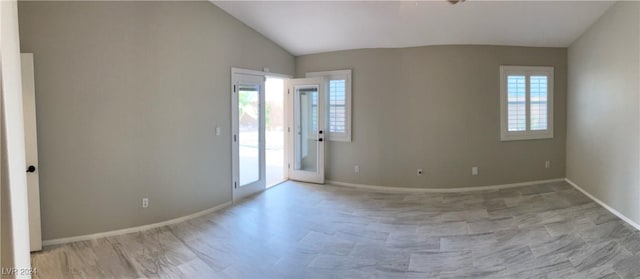 unfurnished room with lofted ceiling