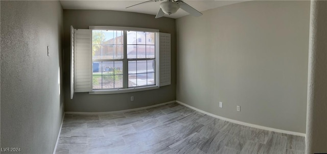 spare room featuring a healthy amount of sunlight and ceiling fan