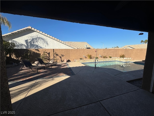 view of swimming pool featuring a patio area