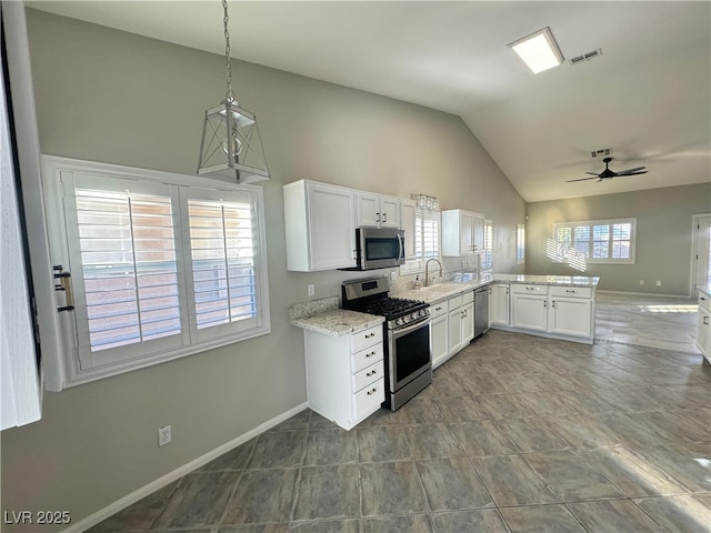 kitchen with sink, hanging light fixtures, appliances with stainless steel finishes, kitchen peninsula, and white cabinets