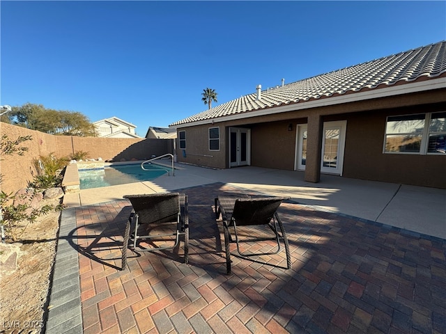 view of patio / terrace featuring french doors and a fenced in pool