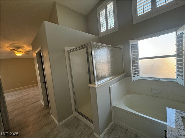 bathroom featuring vanity, hardwood / wood-style flooring, and separate shower and tub