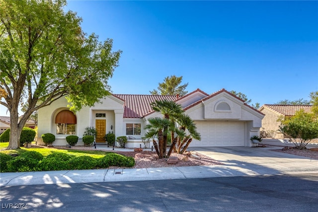 mediterranean / spanish home with a garage