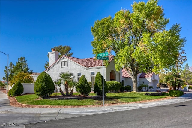 mediterranean / spanish-style house with a front yard