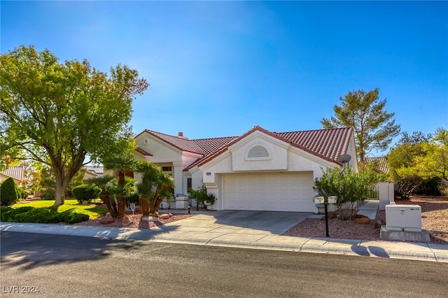 mediterranean / spanish-style home featuring a garage