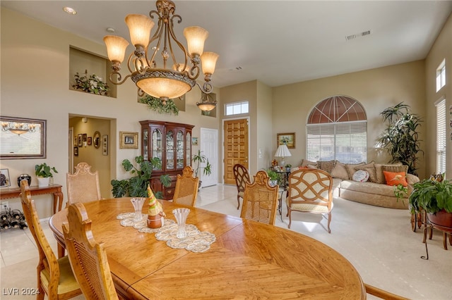 dining area featuring a chandelier, a healthy amount of sunlight, and light tile patterned floors