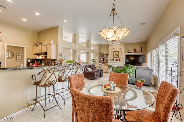 tiled dining room featuring ceiling fan