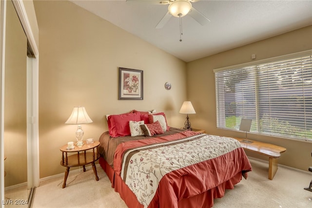 carpeted bedroom with lofted ceiling, a closet, and ceiling fan