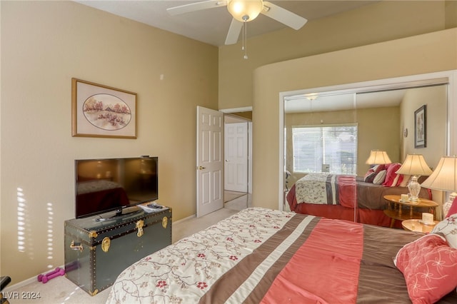 bedroom featuring light colored carpet, a closet, and ceiling fan