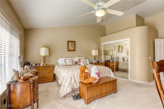 carpeted bedroom featuring a closet, ceiling fan, and lofted ceiling