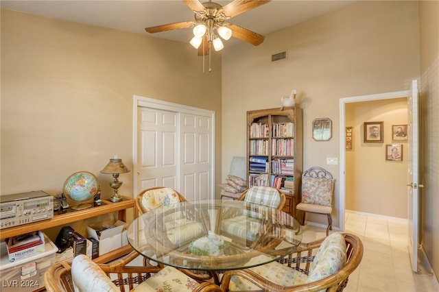 tiled dining space with ceiling fan