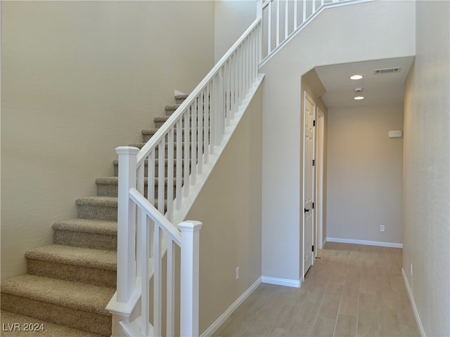 staircase featuring wood-type flooring