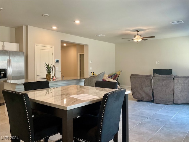 tiled dining room with ceiling fan