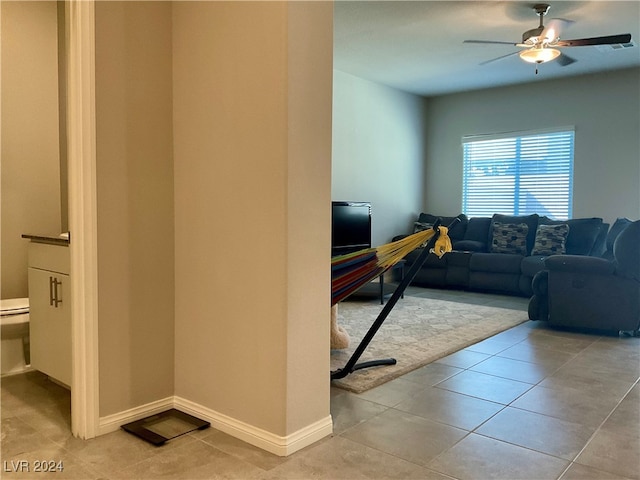 tiled living room featuring ceiling fan