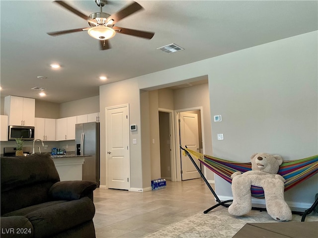 living room with sink and ceiling fan