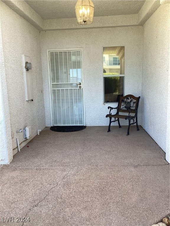 entrance to property featuring a patio area