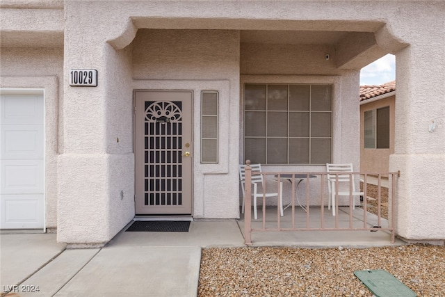 property entrance featuring a patio area