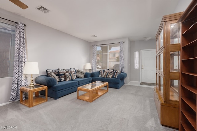 carpeted living room featuring ceiling fan