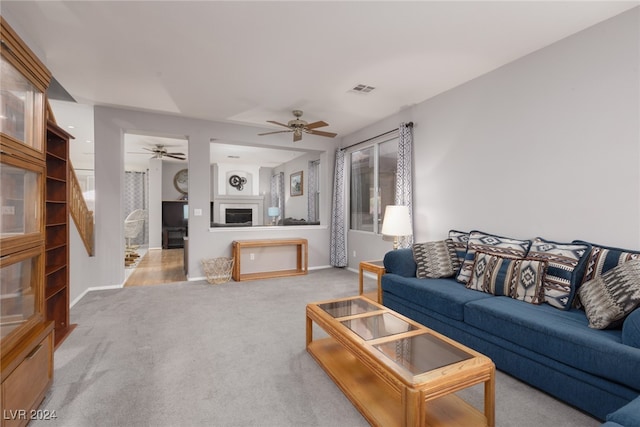 carpeted living room featuring ceiling fan