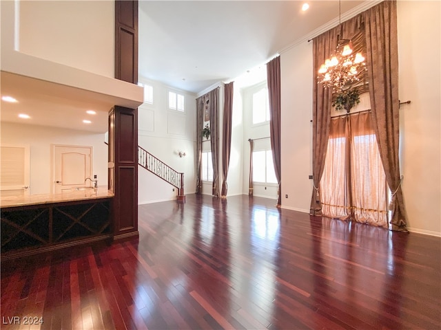 unfurnished room featuring dark wood-type flooring and ornamental molding