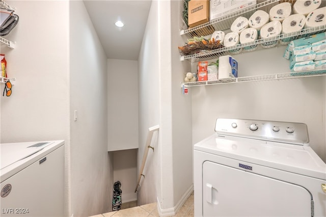 washroom with washer and dryer and light tile patterned floors