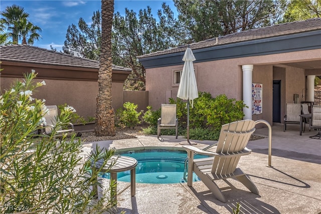 view of swimming pool with a patio area and a community hot tub