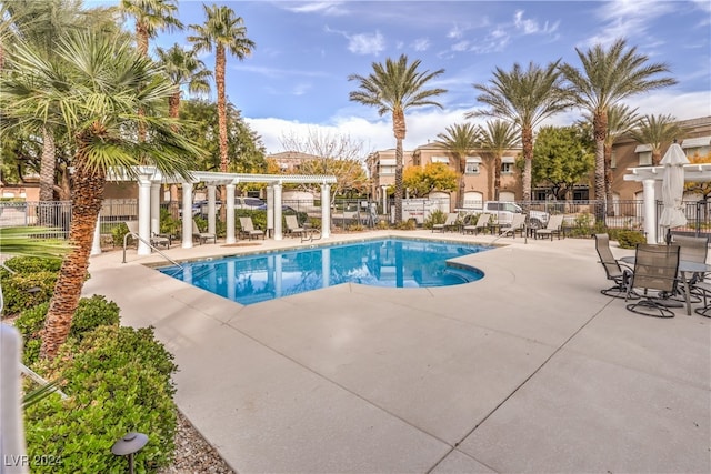 view of swimming pool featuring a pergola and a patio