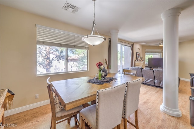 dining space featuring ceiling fan, decorative columns, light hardwood / wood-style floors, and plenty of natural light