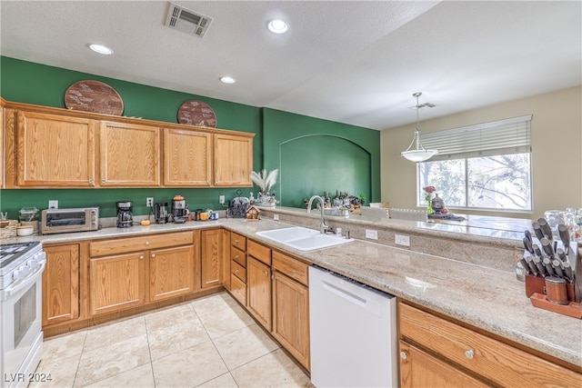 kitchen featuring white appliances, a textured ceiling, sink, and pendant lighting