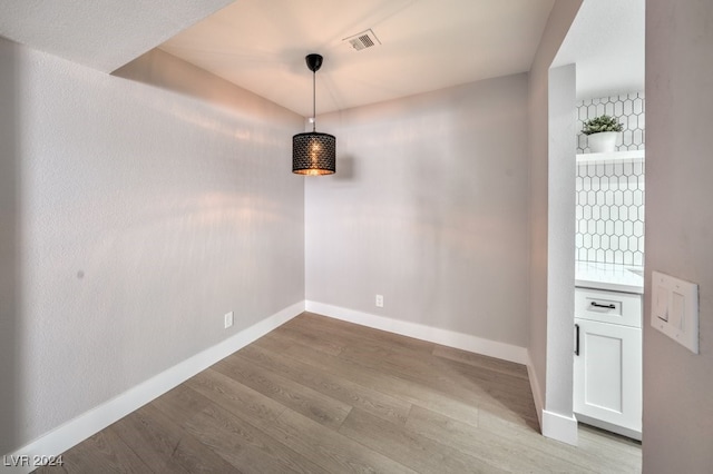 unfurnished dining area with light hardwood / wood-style floors