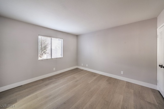 empty room with light hardwood / wood-style flooring