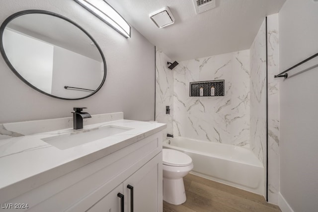 full bathroom featuring toilet, tiled shower / bath, vanity, and wood-type flooring