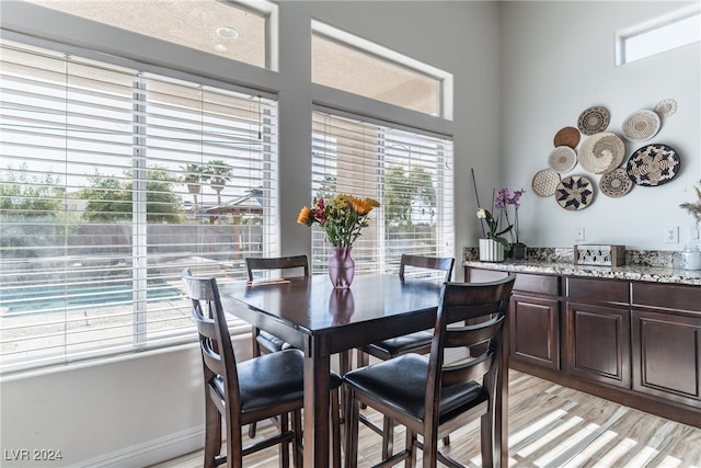 dining area featuring light hardwood / wood-style floors and a textured ceiling