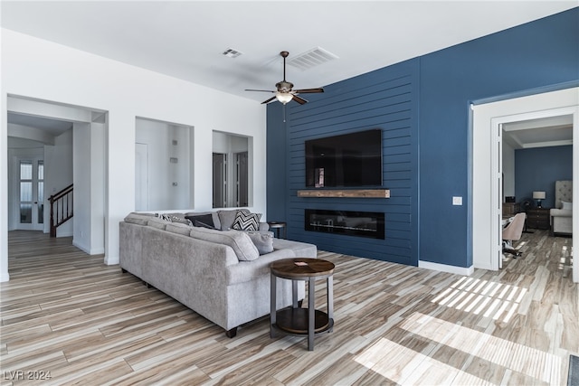 living room featuring light wood-type flooring and ceiling fan