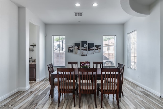 dining space with light hardwood / wood-style flooring and a healthy amount of sunlight