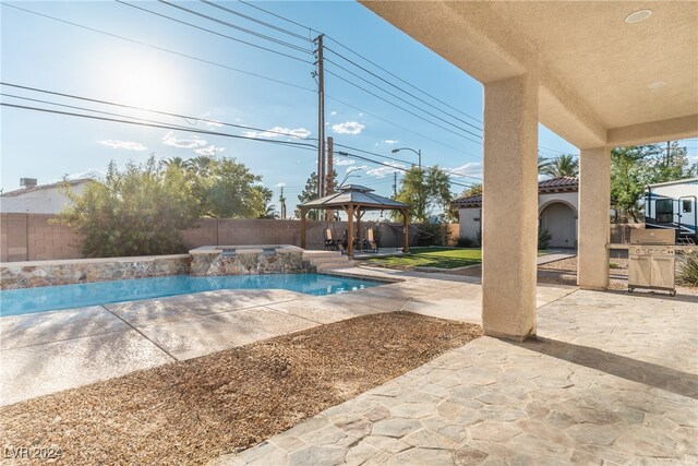 view of swimming pool featuring a patio and a gazebo