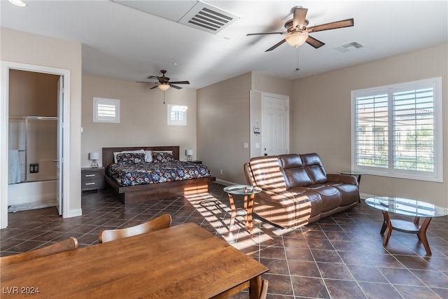 living room with dark tile patterned flooring and ceiling fan