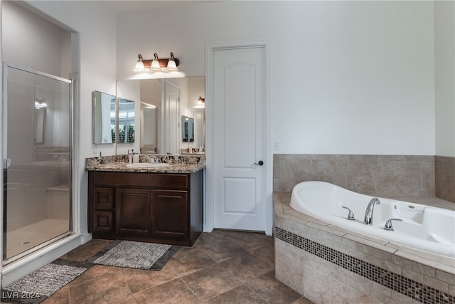 bathroom featuring vanity, plus walk in shower, and tile patterned flooring