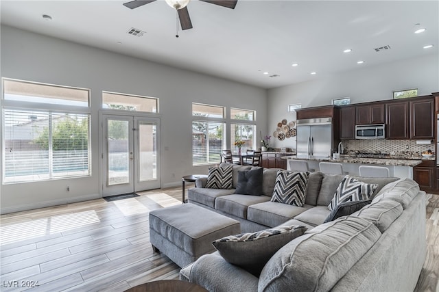 living room featuring light hardwood / wood-style floors and ceiling fan