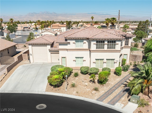 view of front of property with a mountain view and a garage