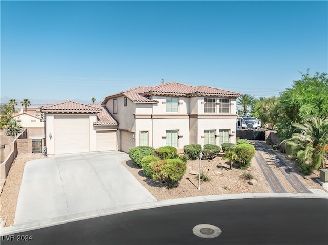 mediterranean / spanish-style home with a garage