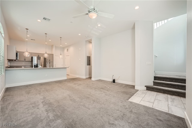 unfurnished living room featuring ceiling fan and light carpet