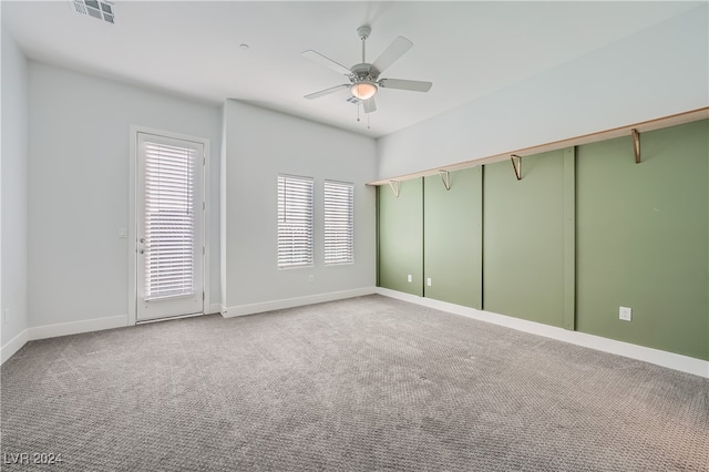 spare room featuring ceiling fan and light colored carpet