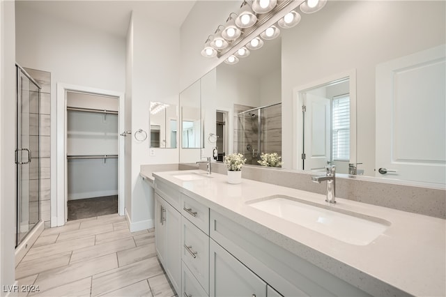 bathroom with vanity and a shower with shower door