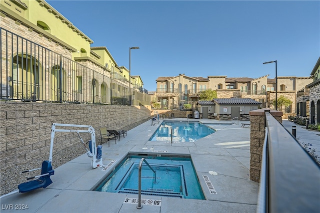 view of swimming pool with a patio and a hot tub