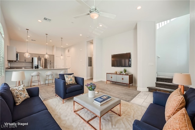 tiled living room featuring ceiling fan