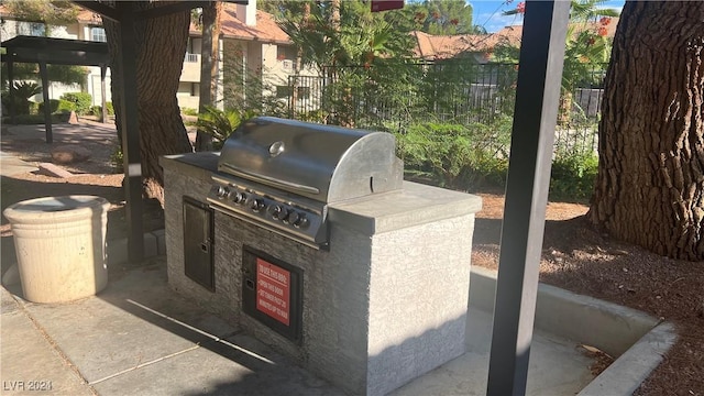 view of patio featuring an outdoor kitchen and a grill