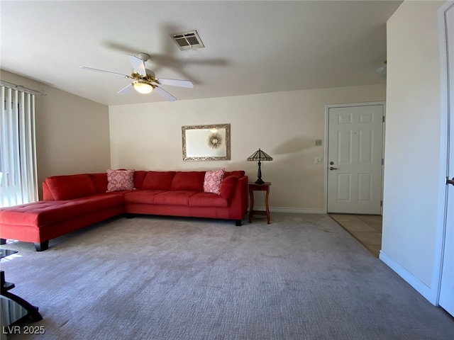 carpeted living room with ceiling fan