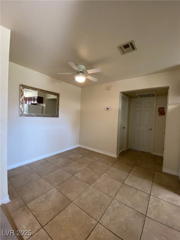 tiled empty room with ceiling fan